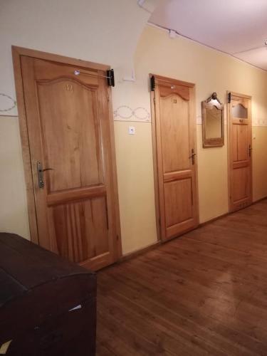 two wooden doors in a room with wood floors at Villa Hubertus in Srebrna Góra