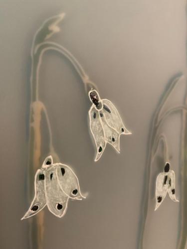 a pair of earrings with leaves on a wall at penzion a kemp Harasov in Vysoká