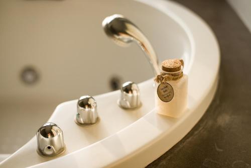 a soap dispenser sitting on a sink in a bathroom at The Houben - Adult Only in Ko Lanta