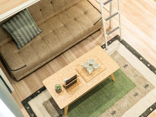 an overhead view of a coffee table in front of a couch at TRIP POD MINOSHIMA A in Fukuoka