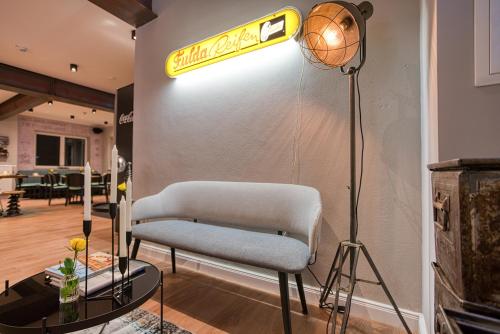 a room with a chair and a sign on a wall at Vienna House Easy by Wyndham Ingolstadt in Ingolstadt