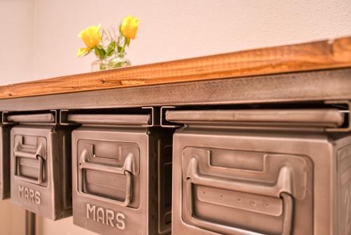 a close up of a fireplace with a vase of flowers at Vienna House Easy by Wyndham Ingolstadt in Ingolstadt
