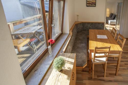 a room with a table and chairs and a window at Cozy Old Town Apartment in Hall in Tirol
