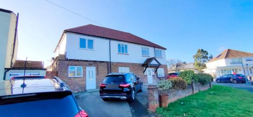 a car parked in a parking lot in front of a house at Apple garden B-5 in London