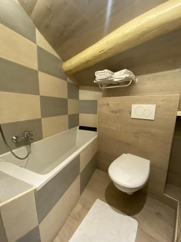 a bathroom with a toilet and a sink and a tub at Le Strasbourg Hotel in Montpellier