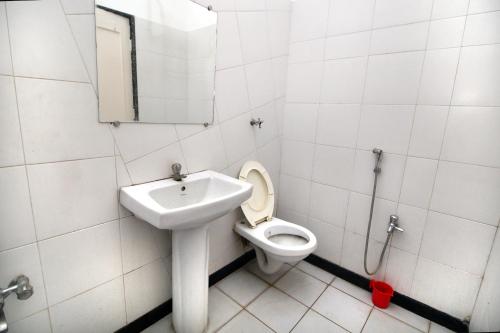 a bathroom with a toilet and a sink at Hotel Gomatgiri in Aurangabad