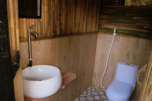 Pandora Glamping في Quezon: حمام مع حوض ومرحاض