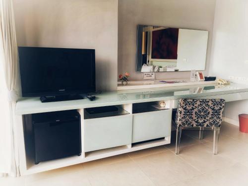 A television and/or entertainment center at The Houben - SHA Extra Plus