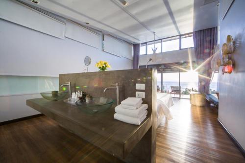 a bathroom with two sinks and a counter with towels at The Houben - Adult Only in Ko Lanta