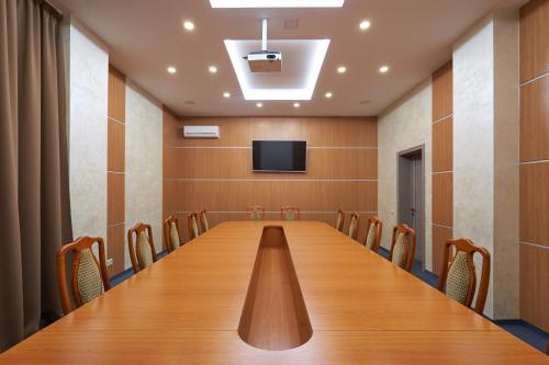 a long conference room with a long table and chairs at Hotel Druzhba in Kyiv