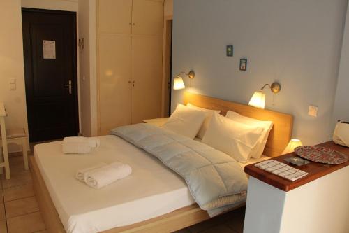 a bedroom with a bed with two towels on it at Villa Martha in Benitses