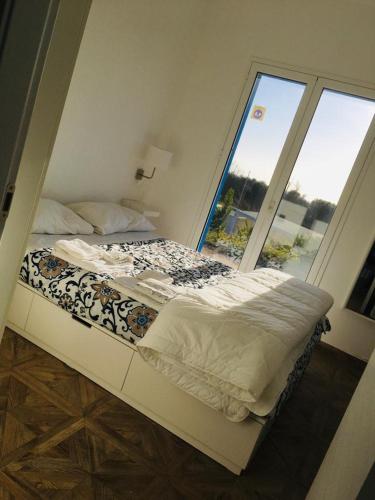 a bed in a room with a large window at Casa Collis in San Leone
