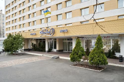 基輔的住宿－Hotel Druzhba，建筑前方有标志的酒店