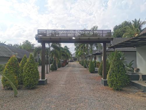 a bench sitting on top of a walk way at Lung Pod 9 resort in Chumphon