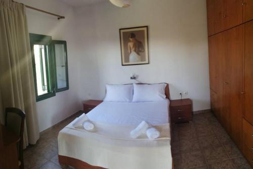 a bedroom with a large white bed in a room at Strofi House in Argoulés