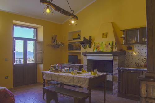 a living room with a table and a fireplace at Montanari Agrivillage in Narni