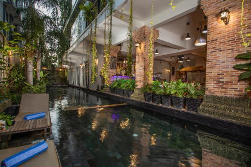 a indoor pool in a building with plants at Cambana Residence in Siem Reap