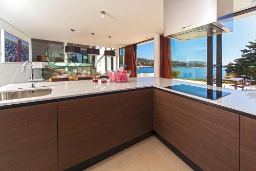 a kitchen with a view of the water at Golden Rays Luxury Villas & Apartments in Primošten
