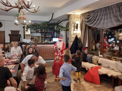 a group of people in a living room with santa at Horlog Castle in Trigrad