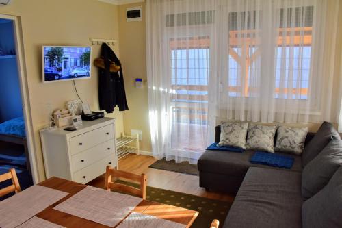 a living room with a couch and a table at Kéknefelejcs Vendégház in Zalakaros