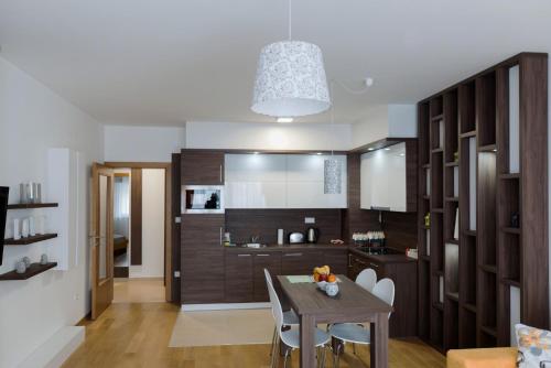a kitchen and dining room with a table and chairs at Turistic Apartments Centar Sarajevo in Sarajevo