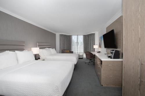 a hotel room with two beds and a television at Crowne Plaza Costa Mesa Orange County by IHG in Costa Mesa
