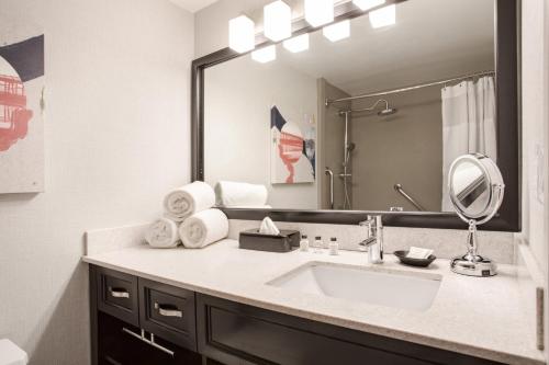a bathroom with a sink and a mirror at Crowne Plaza Costa Mesa Orange County by IHG in Costa Mesa