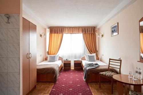 מיטה או מיטות בחדר ב-Hotel Druzhba