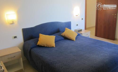een blauw bed met twee gele kussens erop bij Residence Marina di Carlino Tourist in Gallipoli