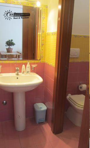 a bathroom with a sink and a toilet at Residence Marina di Carlino Tourist in Gallipoli