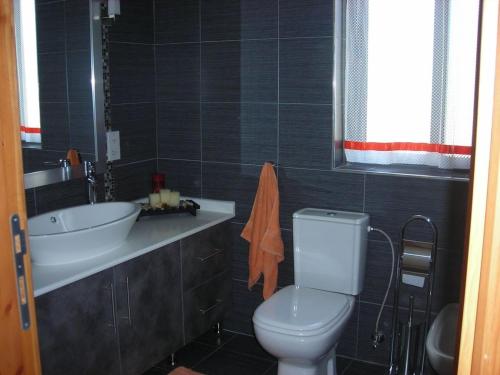 a bathroom with a white toilet and a sink at Apartment in Marsaskala in Marsaskala