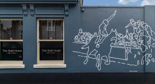 a blue building with a painting on the side of it at The Bold Hotel; BW Signature Collection in Southport
