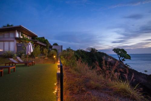 a building with lights on the side of a beach at The Houben - Adult Only in Ko Lanta