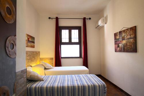 En eller flere senge i et værelse på Appartamenti Stella Marina