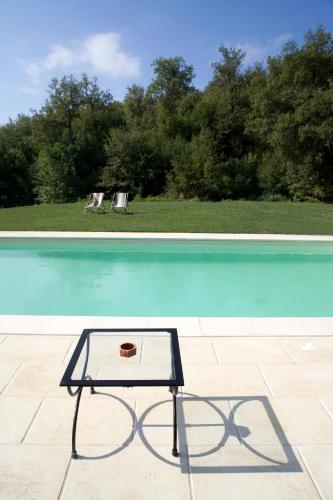 a table sitting next to a swimming pool at All'Antico Silbule in Capolona