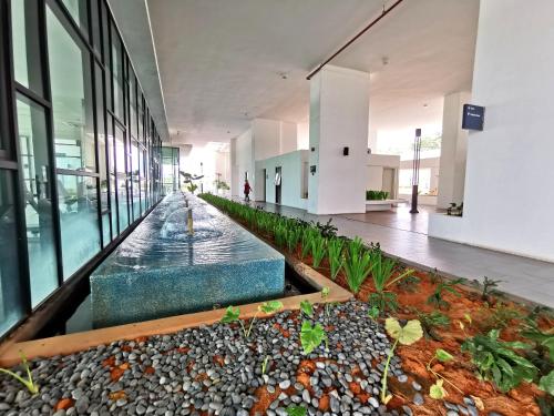 a large building with a water fountain in the middle at Mid Valley Southkey Mosaic Cozy Suite at Johor Bahru in Johor Bahru