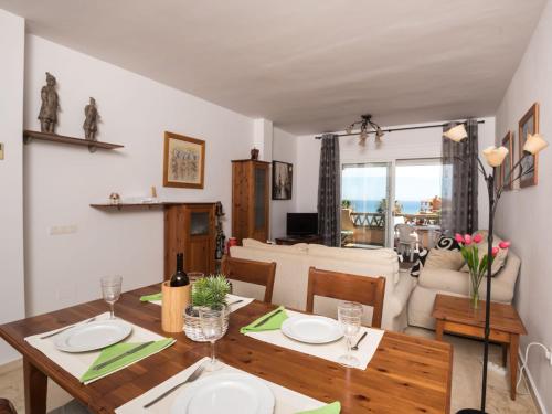 a dining room and living room with a table and chairs at Apartment La joya by Interhome in Fuengirola