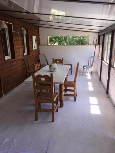 a dining room with a table and chairs at La maison des loirs in Valréas