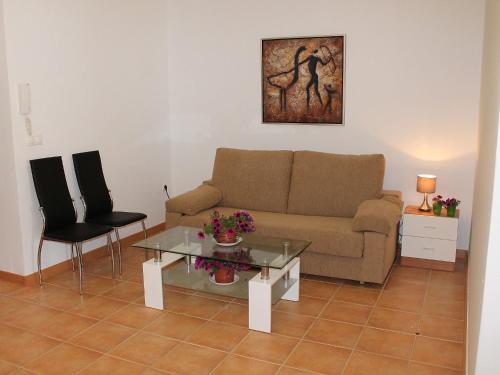 a living room with a couch and a table and chairs at Apartment Albir by Interhome in Altea