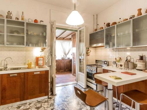 a kitchen with wooden cabinets and a counter top at Apartment La Torretta by Interhome in Florence