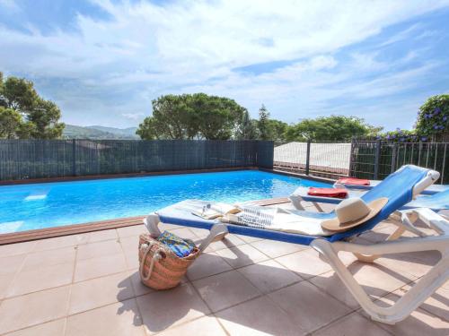 a swimming pool with a lounge chair next to a swimming pool at Holiday Home La Tilia by Interhome in Calonge