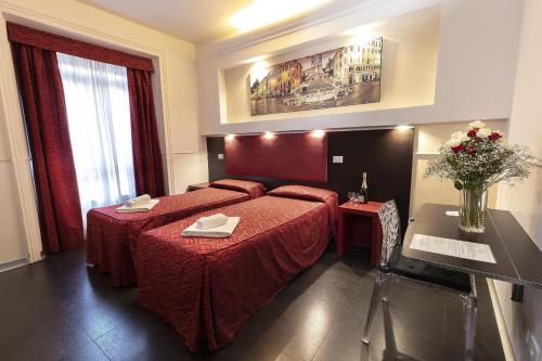a hotel room with a bed with a red bedspread at Imperial Suite Guest House in Rome