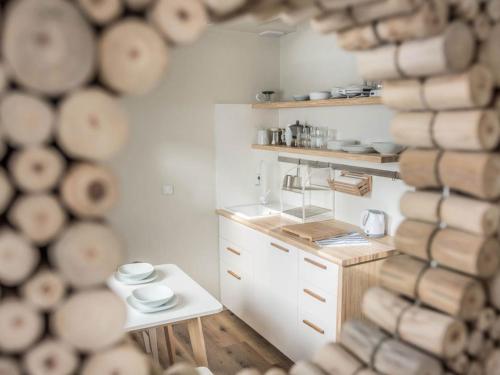a kitchen with a counter and a table with plates at ZAKOPIANA in Zakopane