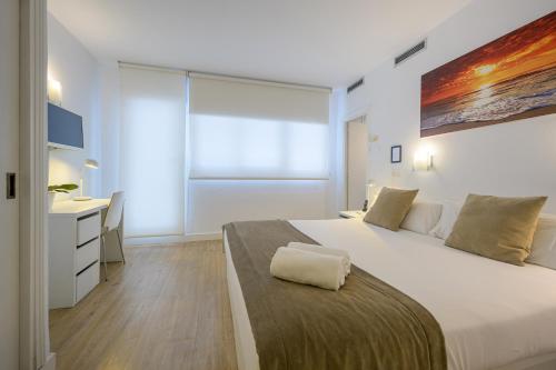 Ein Bett oder Betten in einem Zimmer der Unterkunft NeoMagna Madrid