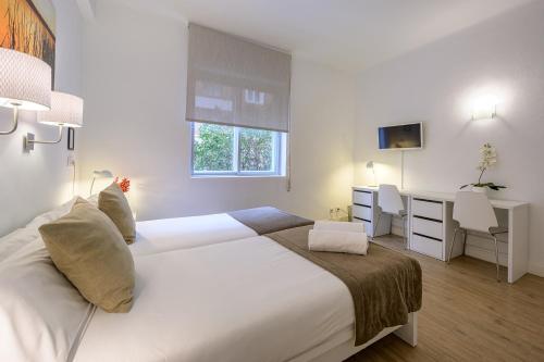 Ein Bett oder Betten in einem Zimmer der Unterkunft NeoMagna Madrid