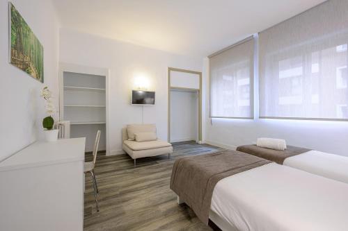 Ein Bett oder Betten in einem Zimmer der Unterkunft NeoMagna Madrid