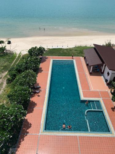 an overhead view of a swimming pool next to the beach at Khanom Beach Residence Monthly Rental Condo in Khanom