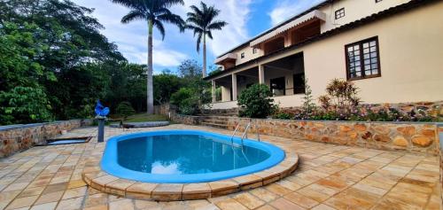 a swimming pool in front of a house at Pousada Café do Brejo in Triunfo