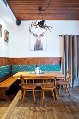 a dining room with a wooden table and chairs at Gasthof Wastlwirt in Salzburg