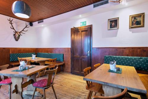 a dining room with wooden tables and chairs at Gasthof Wastlwirt in Salzburg